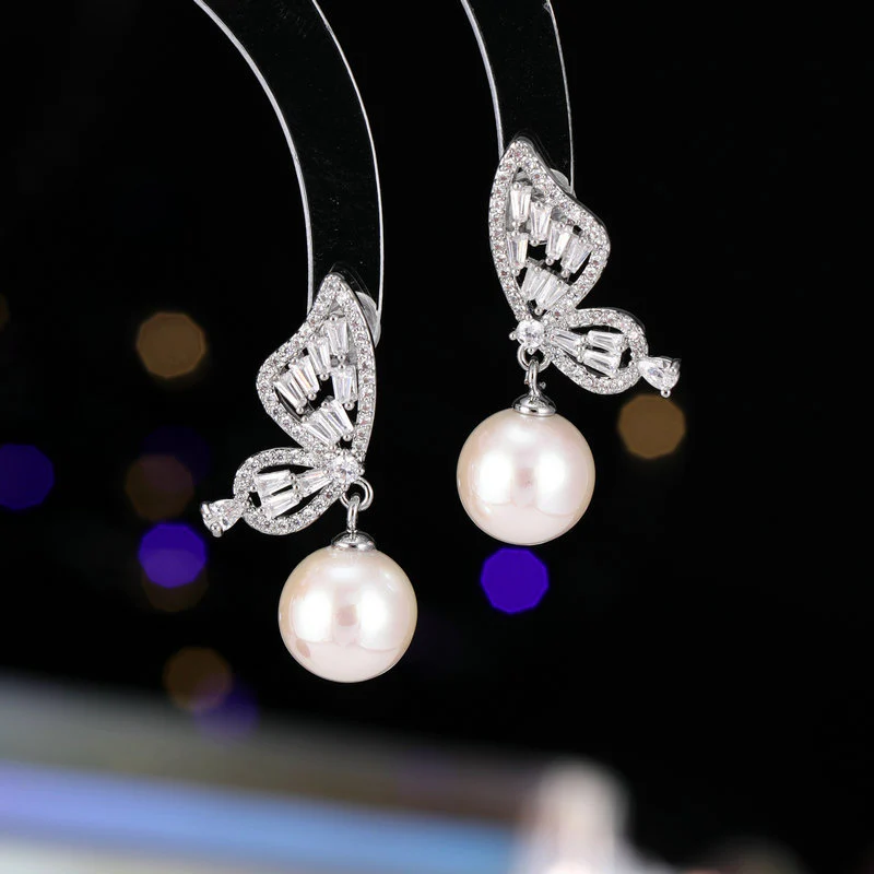 2025 Temperament niche high-end earrings wholesale new trendy fashion small simple zircon inlaid pearl butterfly earrings - Deanwangkt
