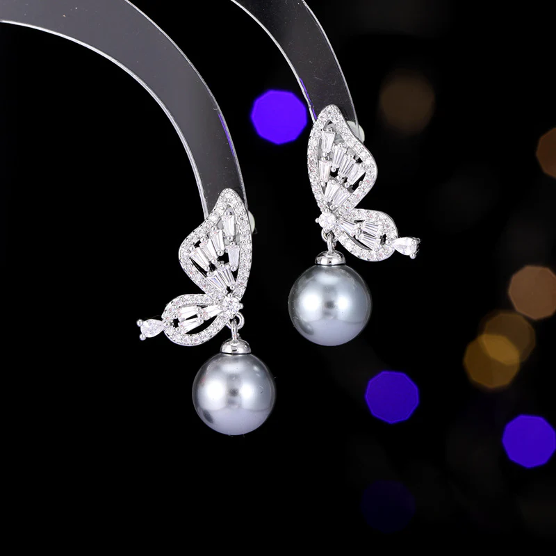 2025 Temperament niche high-end earrings wholesale new trendy fashion small simple zircon inlaid pearl butterfly earrings - Deanwangkt
